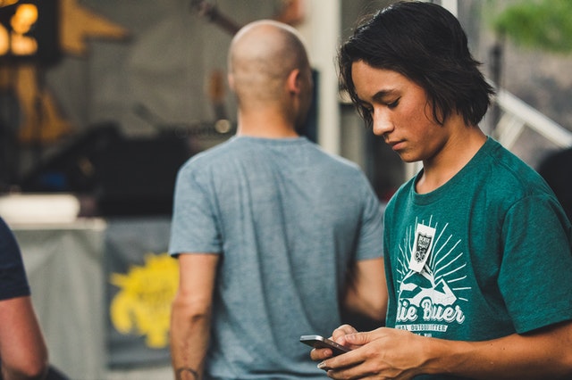 Teenage boy looking at his phone.