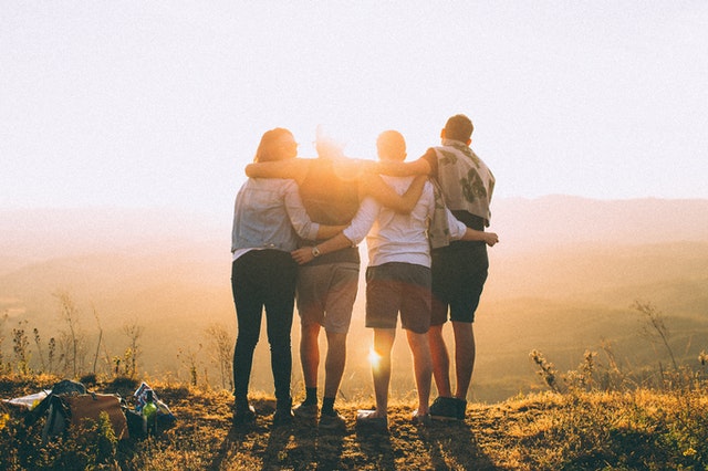 Young people in sobriety hugging each other.