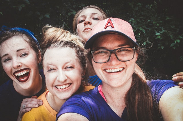 Four women in recovery posing for a selfie photo.