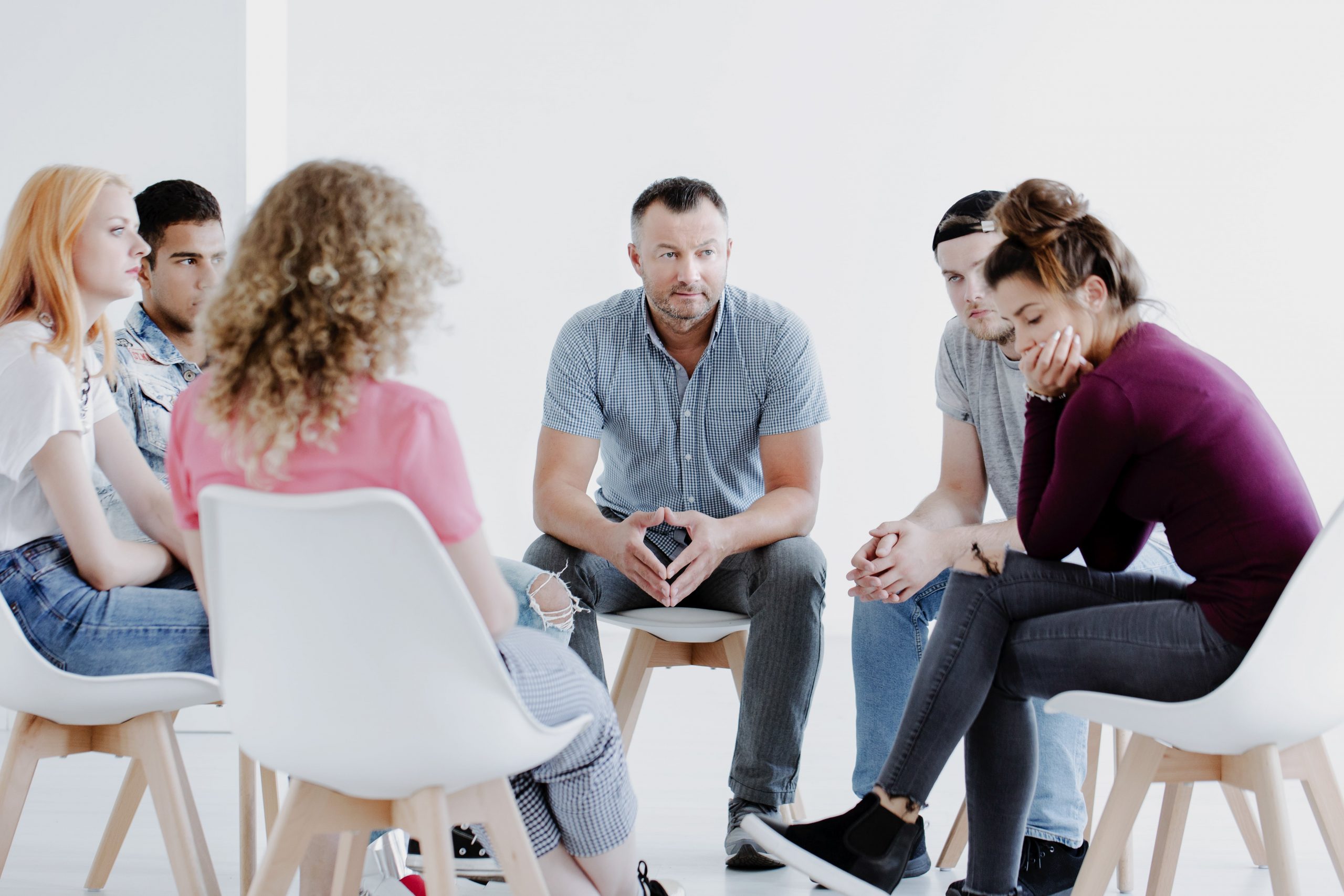 young adults sitting in a circle